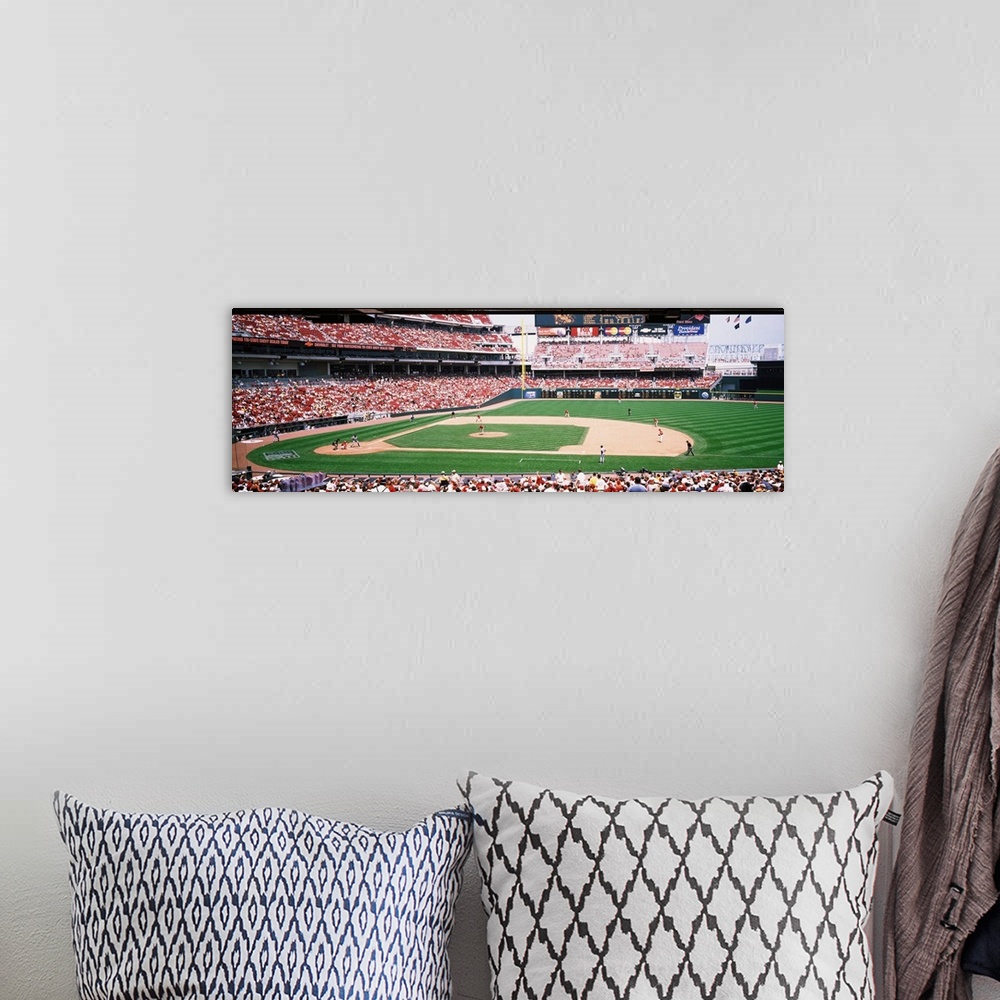 A bohemian room featuring Long horizontal image of a baseball game being played as spectators watch in Ohio.