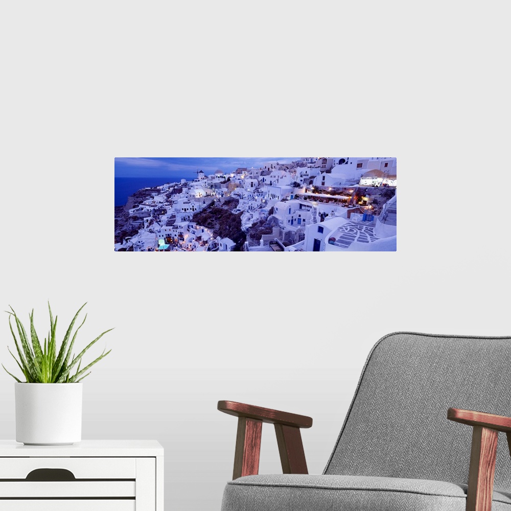 A modern room featuring Long horizontal image on canvas of a city on the side of a mountain overlooking the ocean in Greece.