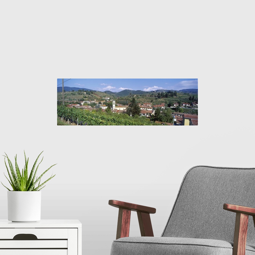 A modern room featuring Panoramic canvas photo of an Italian town on rolling hills.