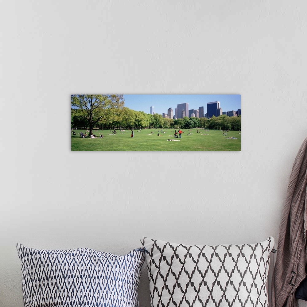 A bohemian room featuring Panoramic view of central park with people relaxing and enjoying the downtown skyline.