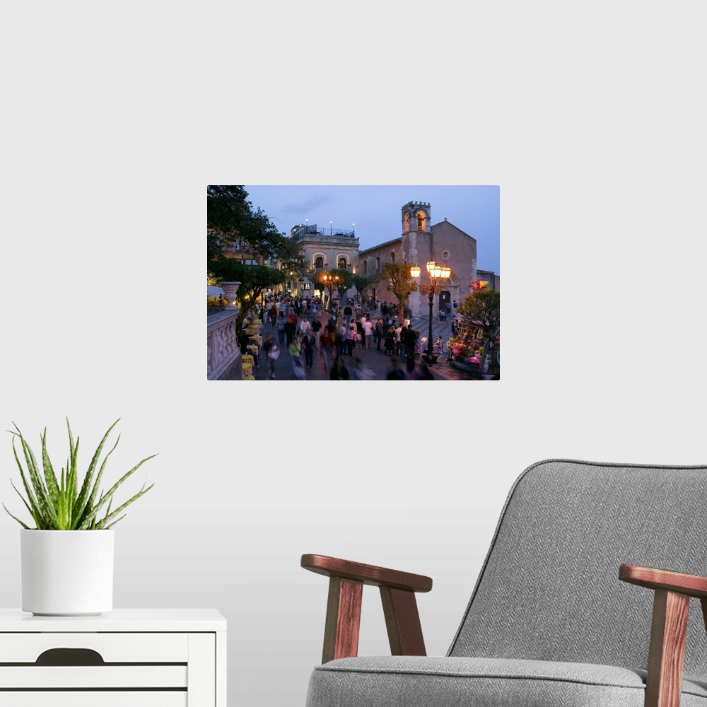 A modern room featuring Group of people on the street at dusk, Piazza IX Aprile, Taormina, Sicily, Italy