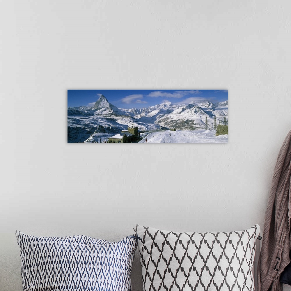 A bohemian room featuring Group of people skiing near a mountain, Matterhorn, Switzerland