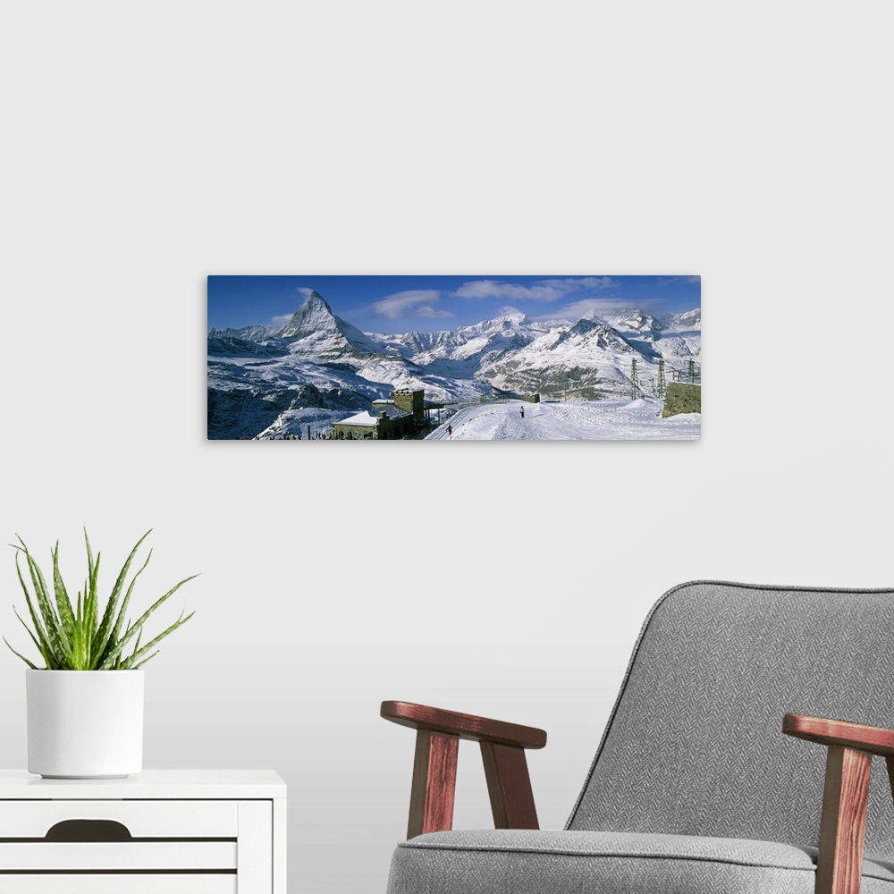 A modern room featuring Group of people skiing near a mountain, Matterhorn, Switzerland