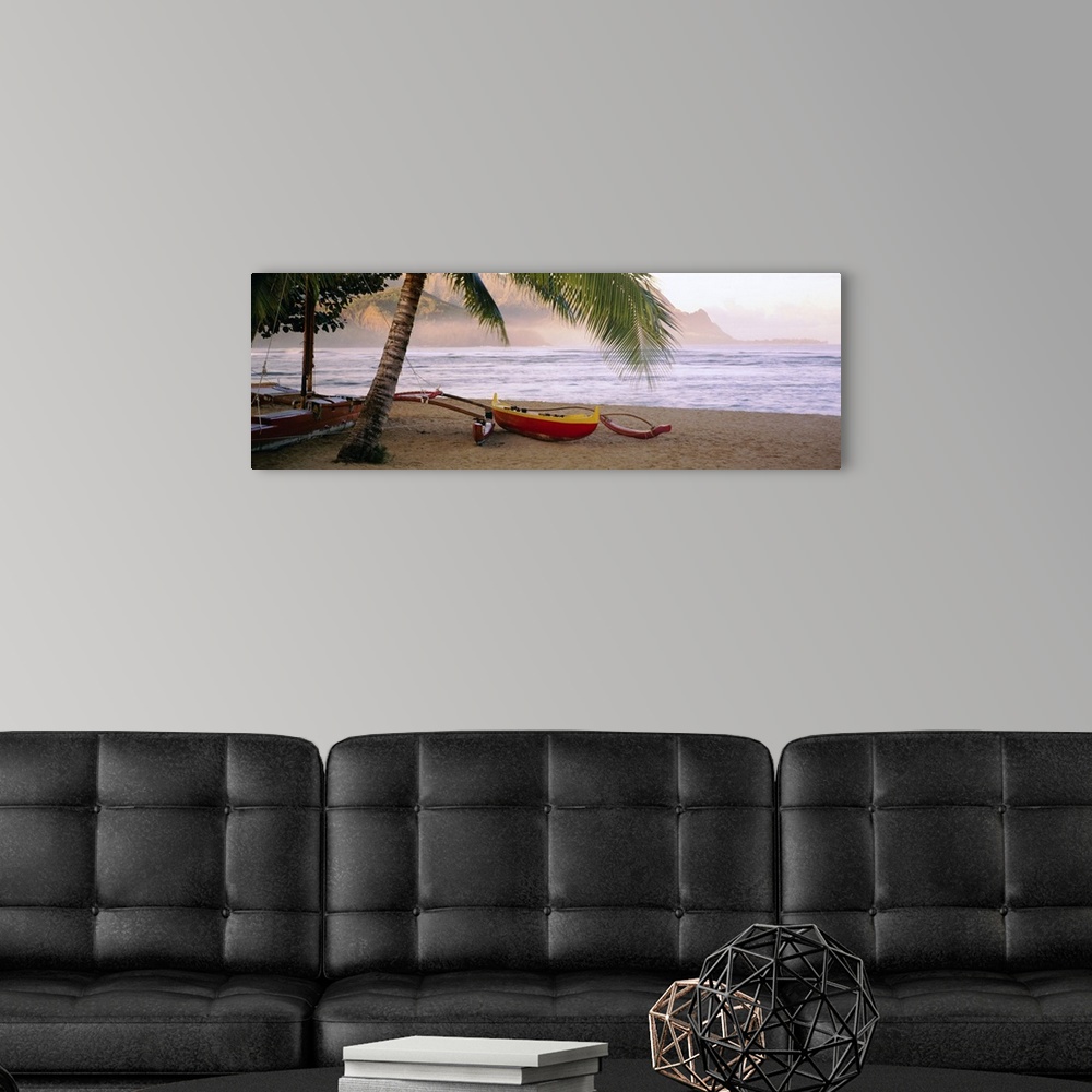 A modern room featuring Panoramic photograph shows a boat sitting beneath a palm tree on the sandy shores of a beach in t...