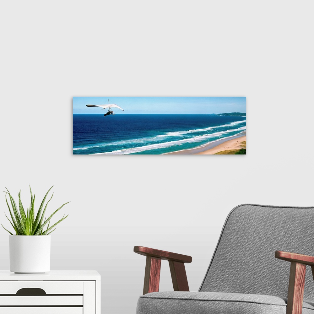 A modern room featuring Hang glider over the sea