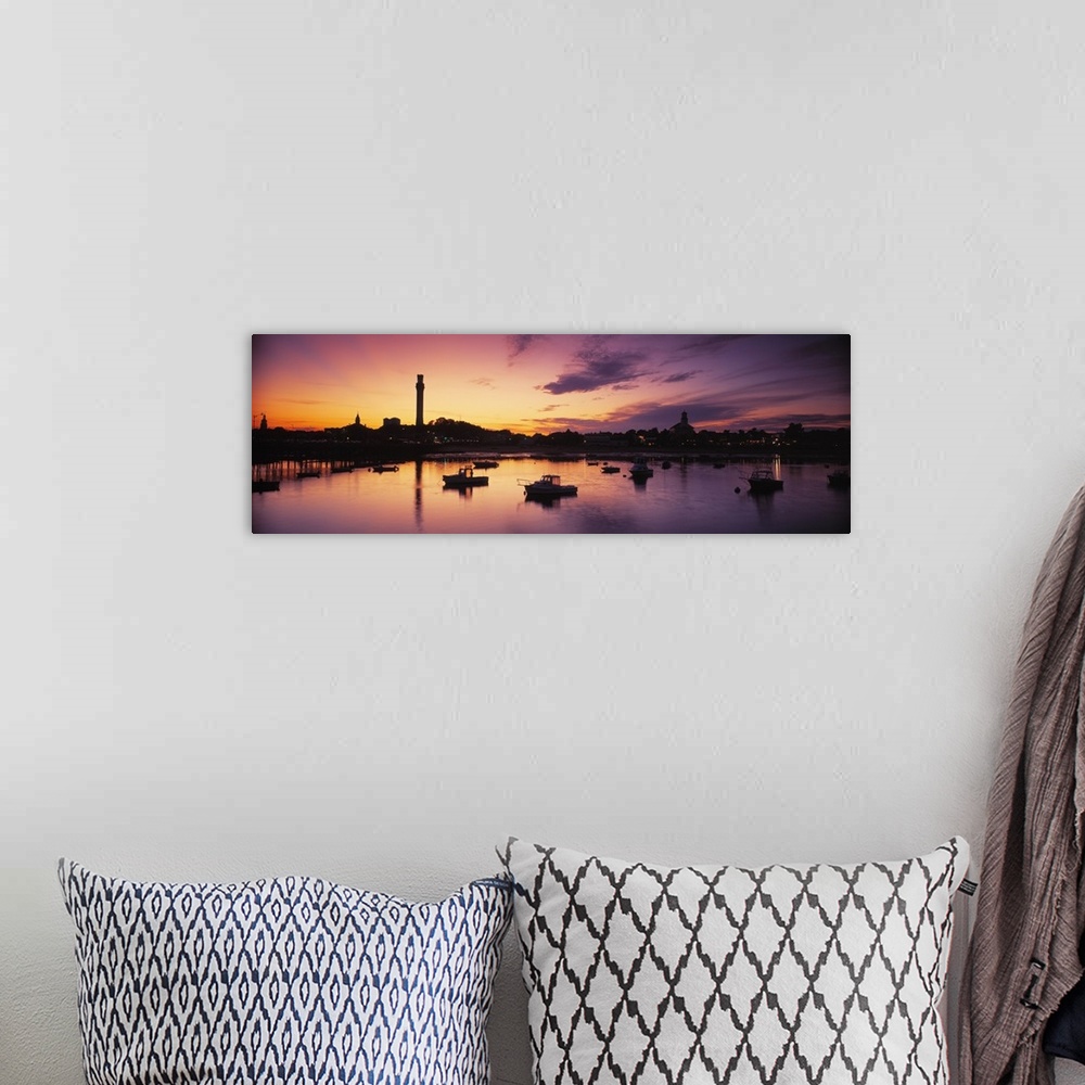 A bohemian room featuring Oversized photograph of the sun setting on the horizon as many boats in a harbor are silhouetted ...
