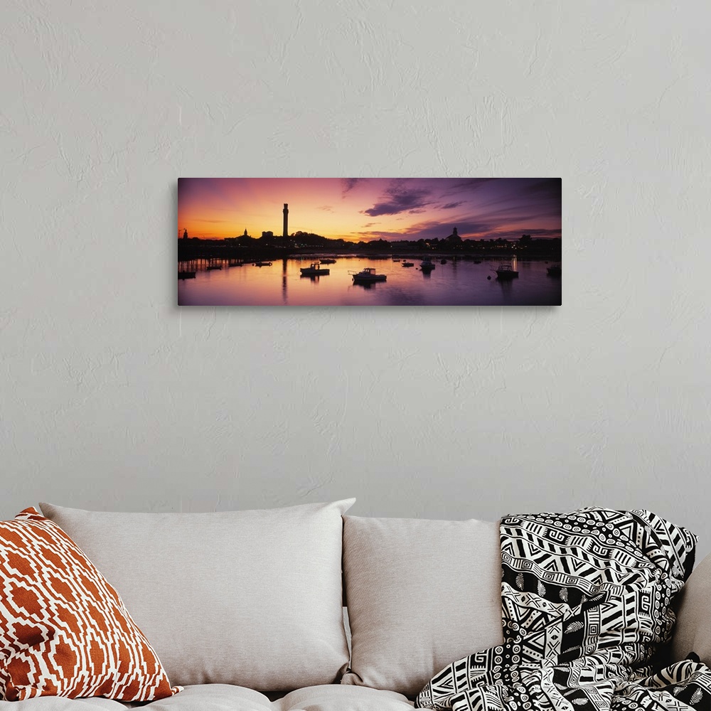 A bohemian room featuring Oversized photograph of the sun setting on the horizon as many boats in a harbor are silhouetted ...