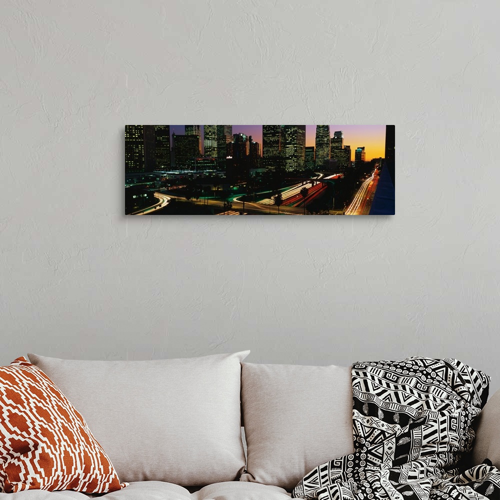 A bohemian room featuring This panoramic photograph of the city roadways was taken with the time lapsed photography techniq...