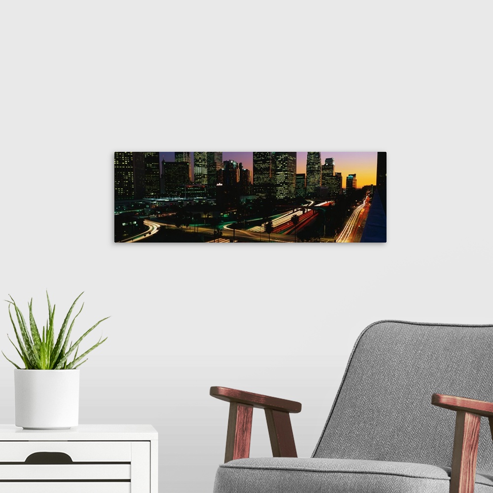 A modern room featuring This panoramic photograph of the city roadways was taken with the time lapsed photography techniq...