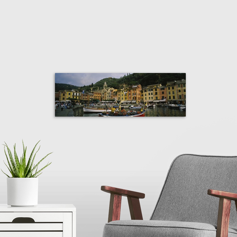 A modern room featuring Panoramic canvas of an Italian boat harbor with a bunch of boats and buildings meeting the water ...