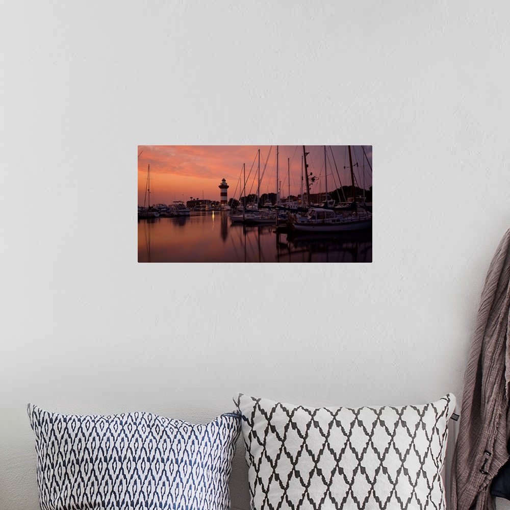 A bohemian room featuring Big photograph displays a marina full of sailboats and other watercraft docked under the dimming ...