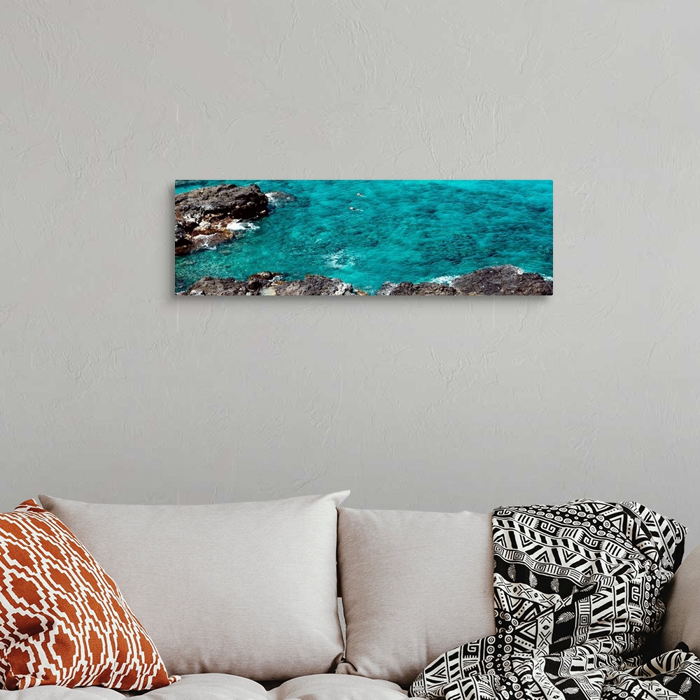 A bohemian room featuring This panoramic photograph shows two figures from distance in clear waters of a reef.