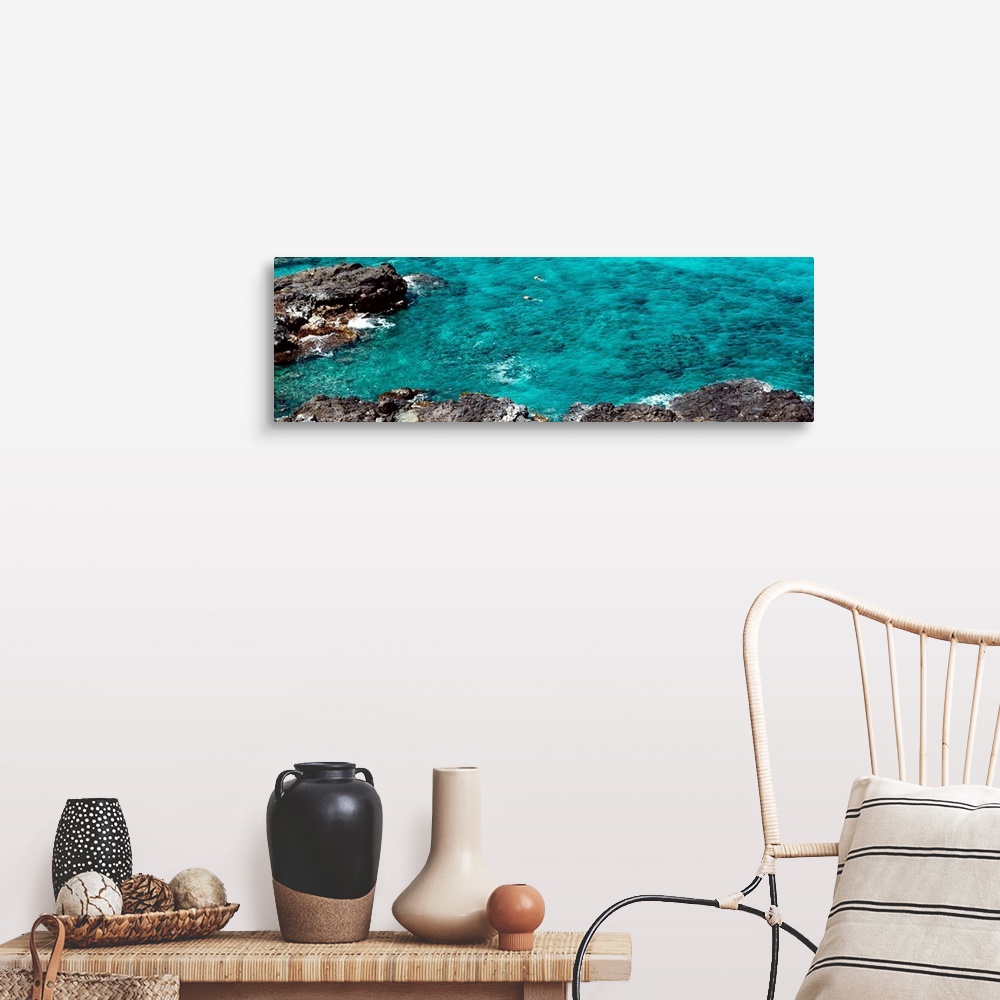 A farmhouse room featuring This panoramic photograph shows two figures from distance in clear waters of a reef.