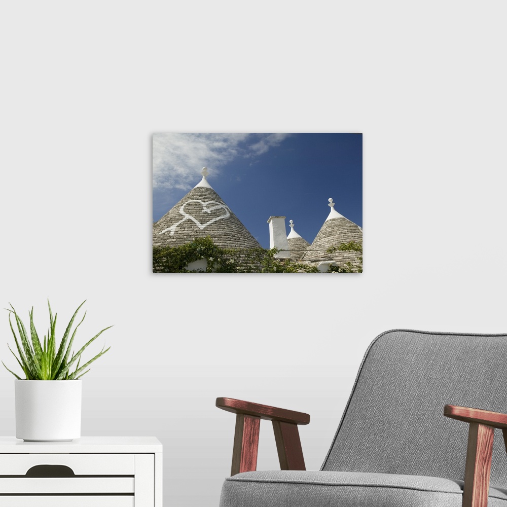 A modern room featuring Heart sign on the roof of a house, Trulli House, Alberobello, Apulia, Italy