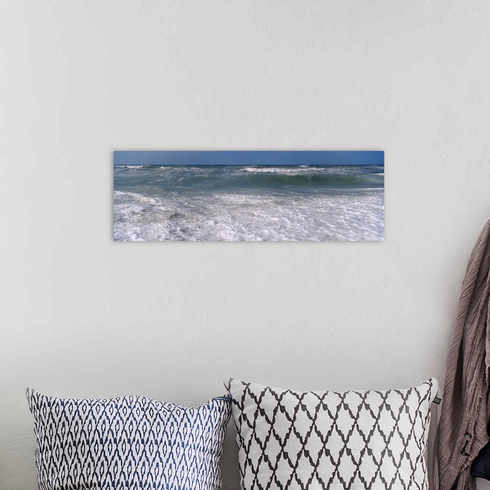 A bohemian room featuring Waves break just of shore in this panoramic photograph of a Gulf Coast beach.