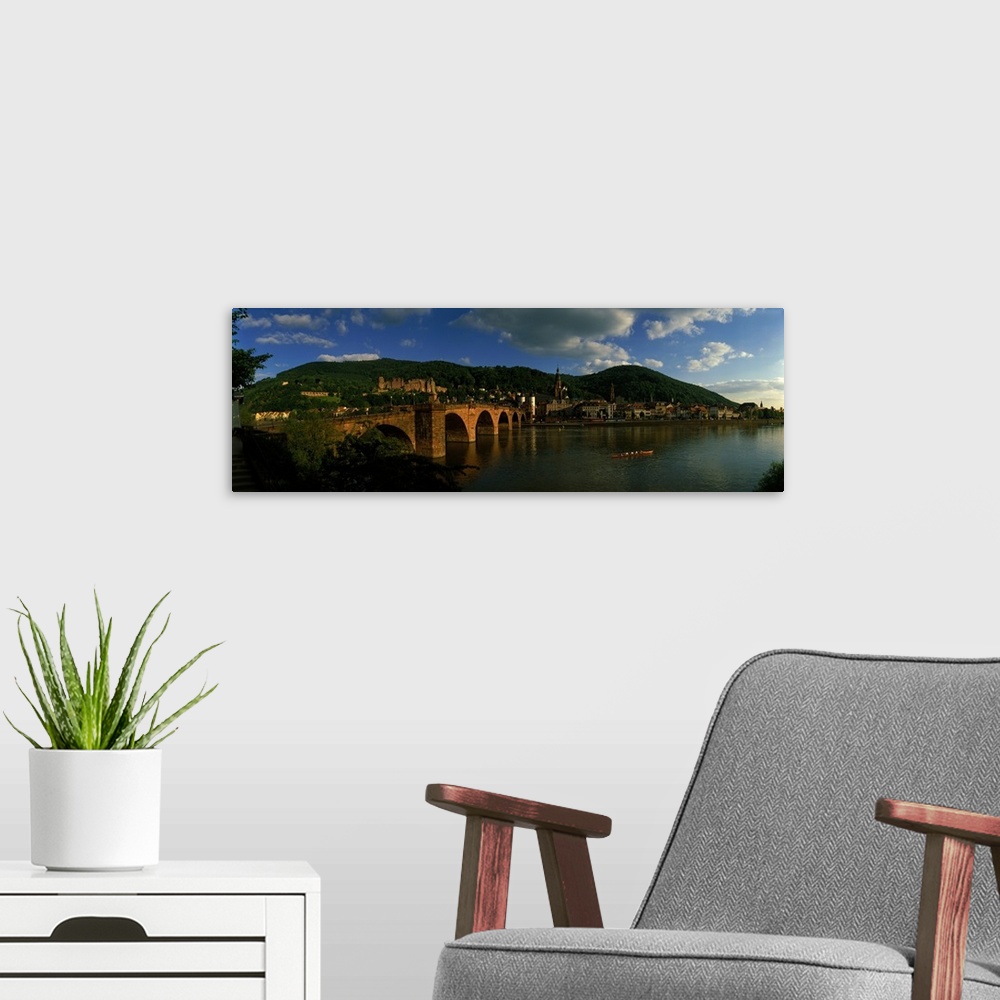 A modern room featuring Panoramic photo on canvas of an old stone bridge entering a German city along the waterfront.