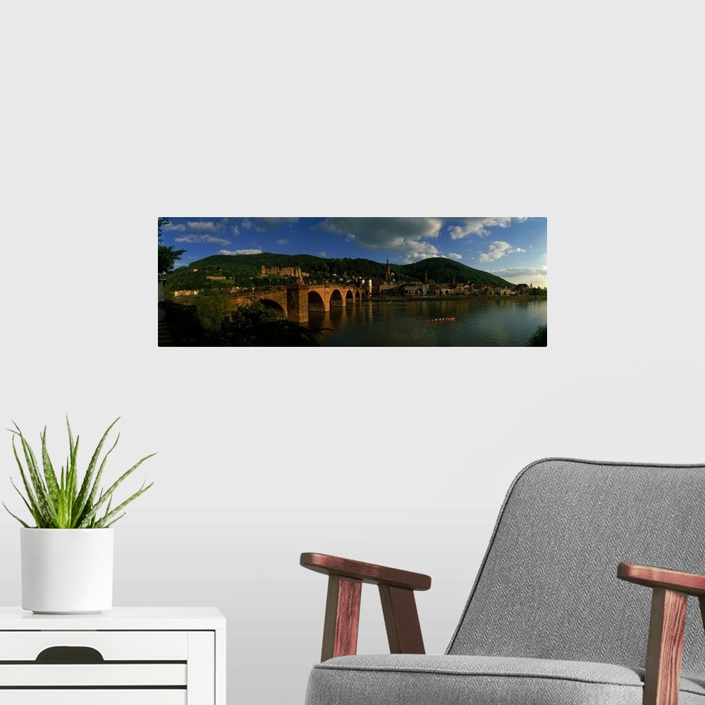 A modern room featuring Panoramic photo on canvas of an old stone bridge entering a German city along the waterfront.