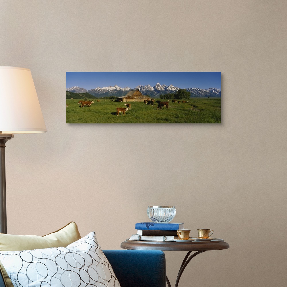 A traditional room featuring Long and narrow photo on canvas of cows in a pasture with a barn and rugged snowy mountains in th...
