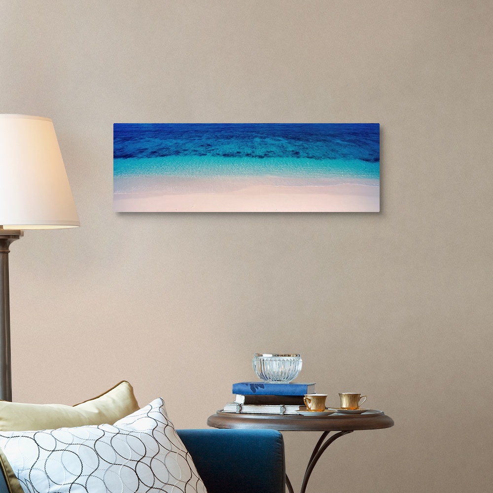 A traditional room featuring Panoramic aerial photograph of vibrant, clear blue waters along the sandy shoreline of Veidomoni ...
