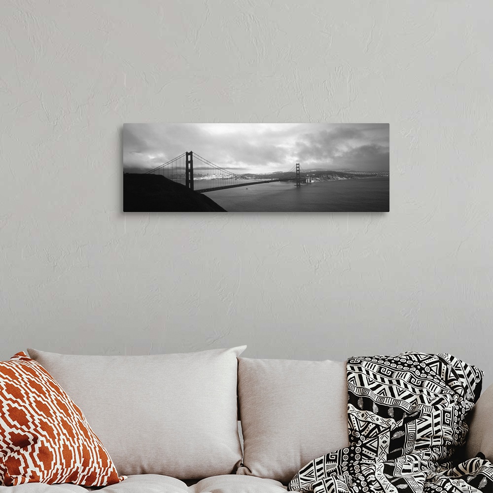 A bohemian room featuring Giant black and white photograph of the Golden Gate Bridge in San Francisco, California (CA) on a...