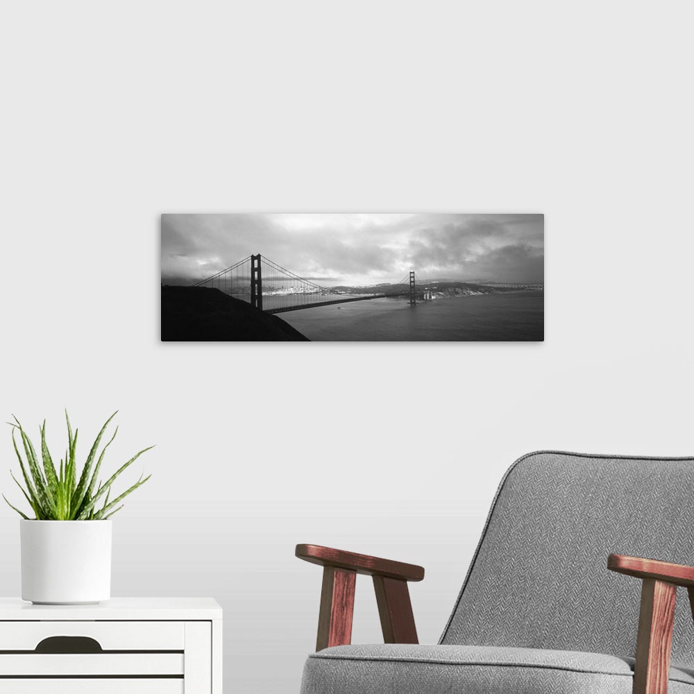 A modern room featuring Giant black and white photograph of the Golden Gate Bridge in San Francisco, California (CA) on a...
