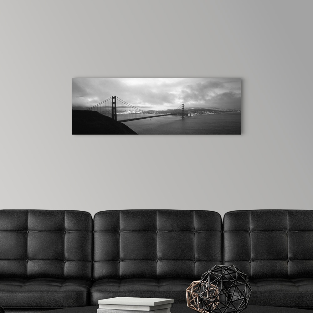 A modern room featuring Giant black and white photograph of the Golden Gate Bridge in San Francisco, California (CA) on a...