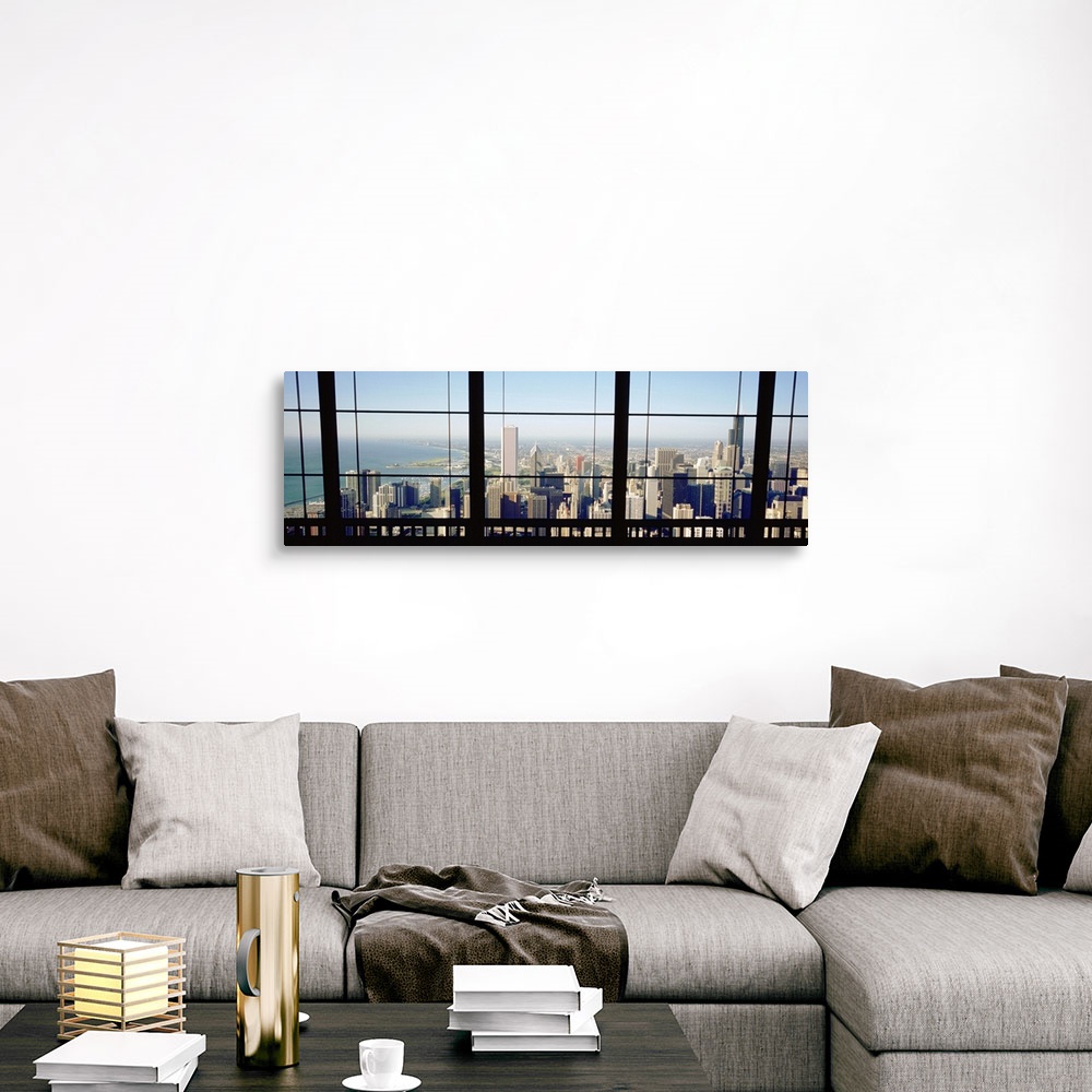 A traditional room featuring Panoramic photograph of skyline and waterfront from behind a window.