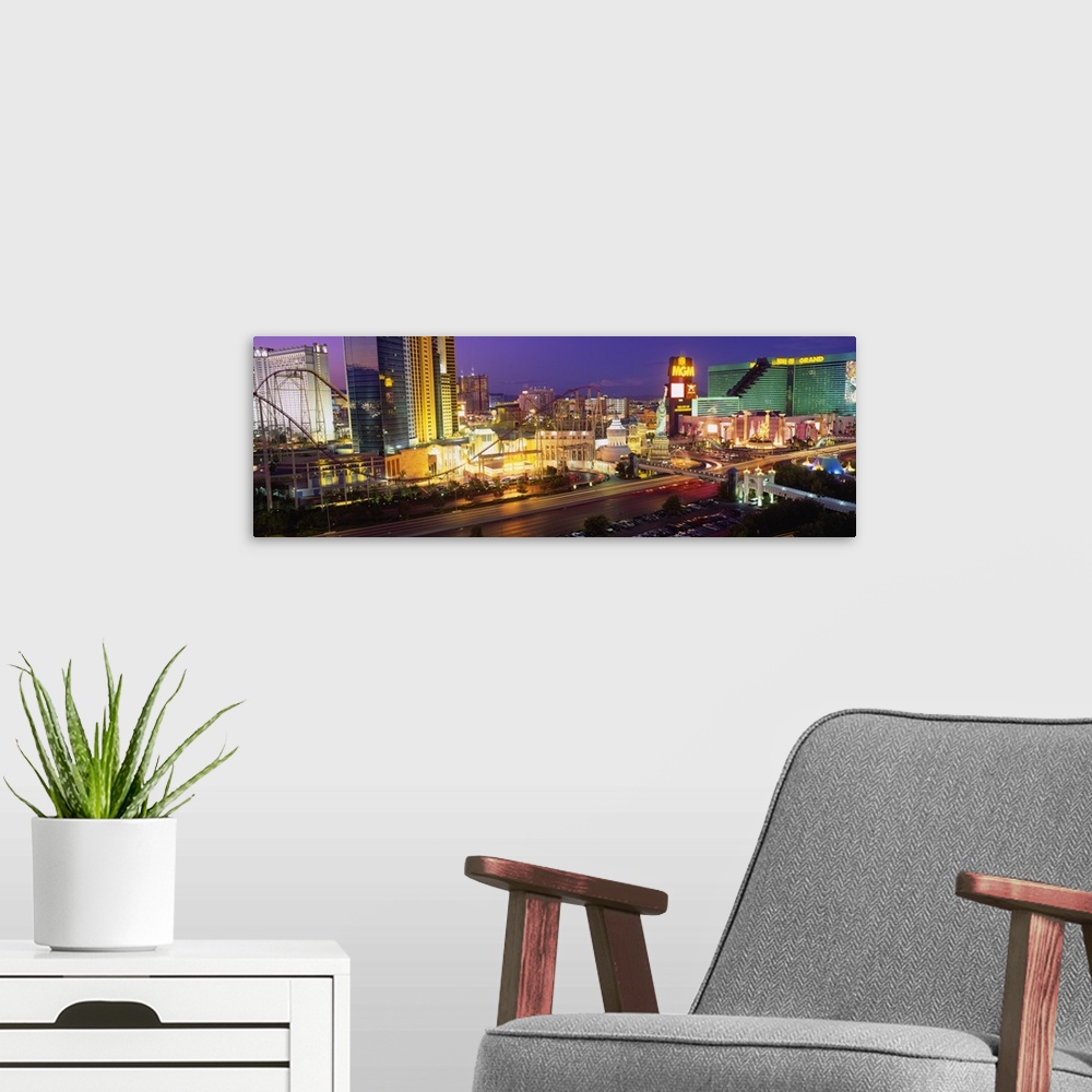 A modern room featuring Panoramic photograph on large canvas of the Las Vegas strip, at night, including New York, New Yo...