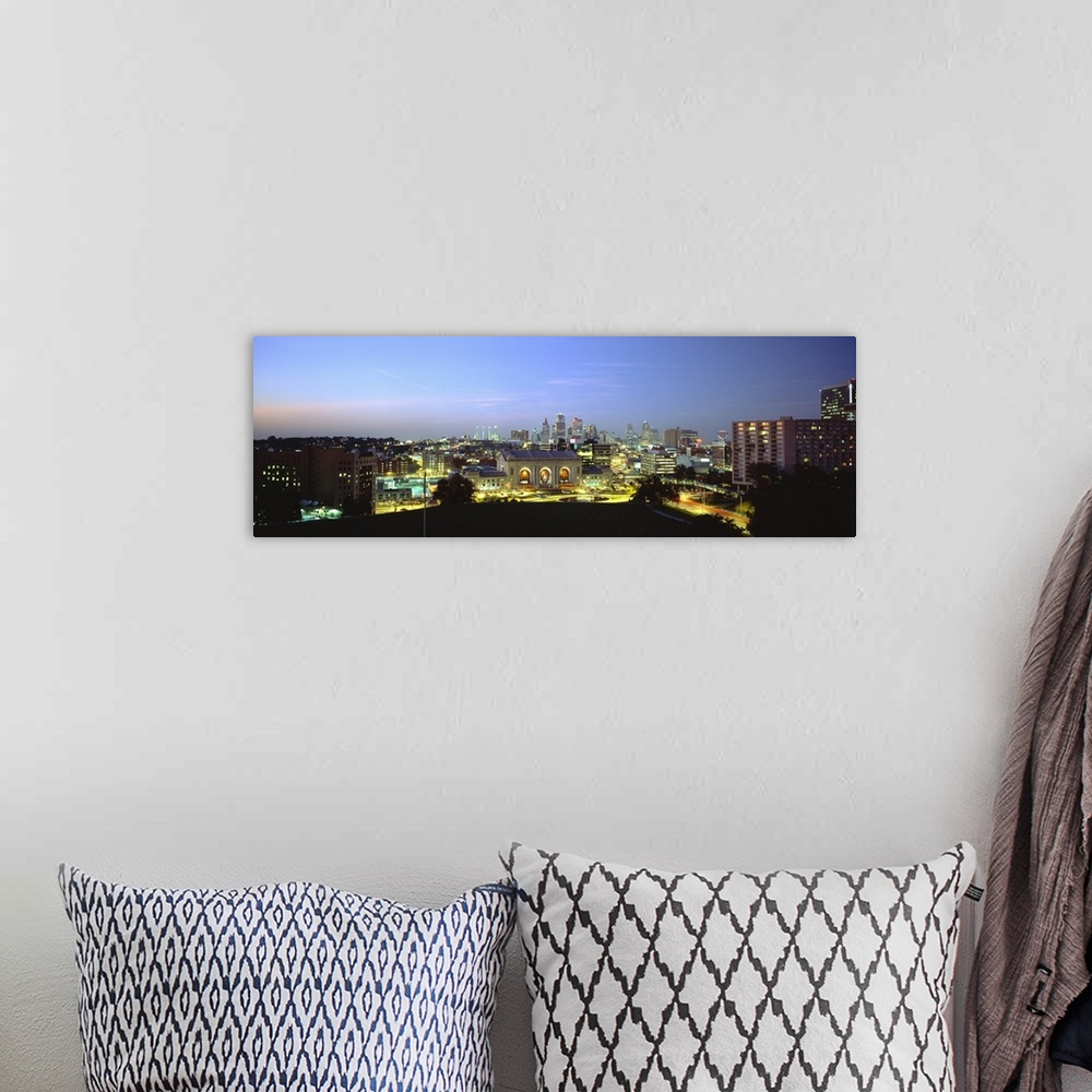 A bohemian room featuring Large panoramic image of a downtown cityscape in Missouri lit up at night.