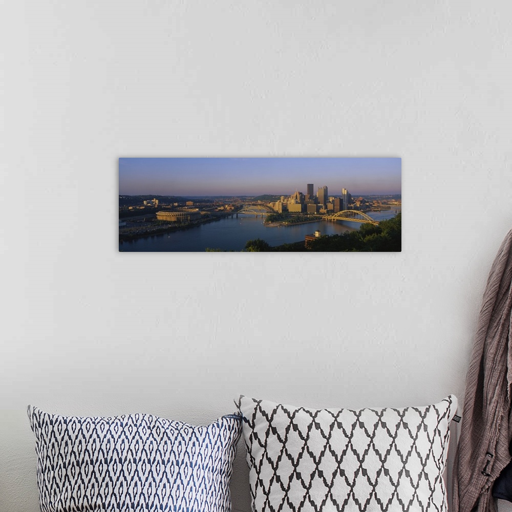 A bohemian room featuring Panoramic photo of the Pittsburgh skyline bathed in morning light, showing skyscrapers and two br...