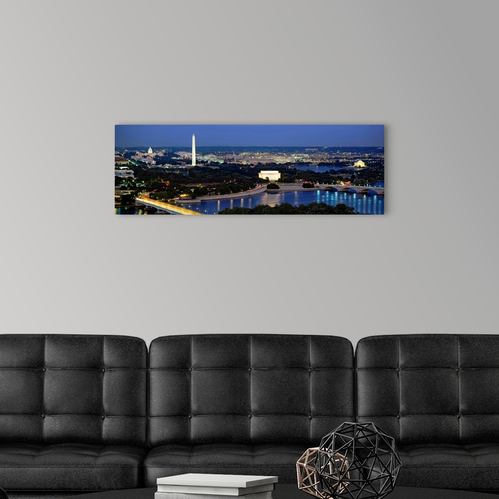 A modern room featuring Panoramic photograph of the nation's capital at night with bright lights reflected in the water. ...
