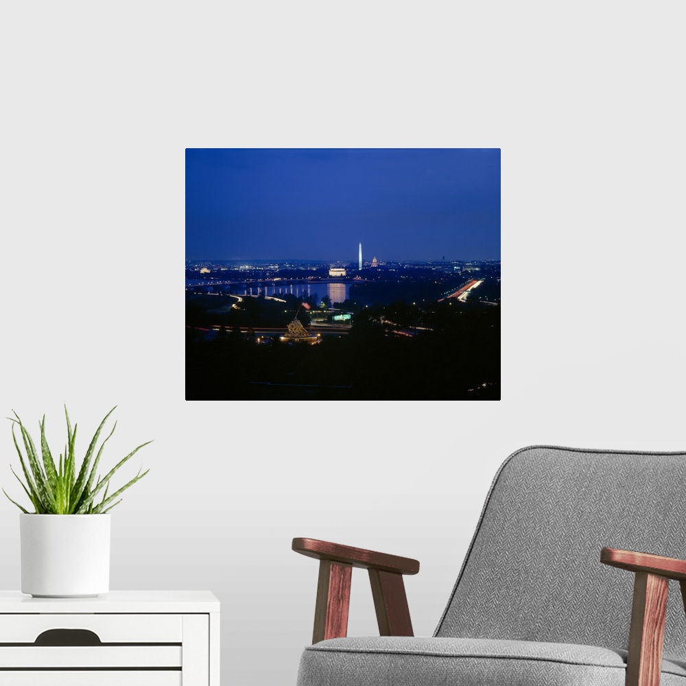 A modern room featuring This large piece is a high angle photograph at night of Washington DC with many monuments lit up ...