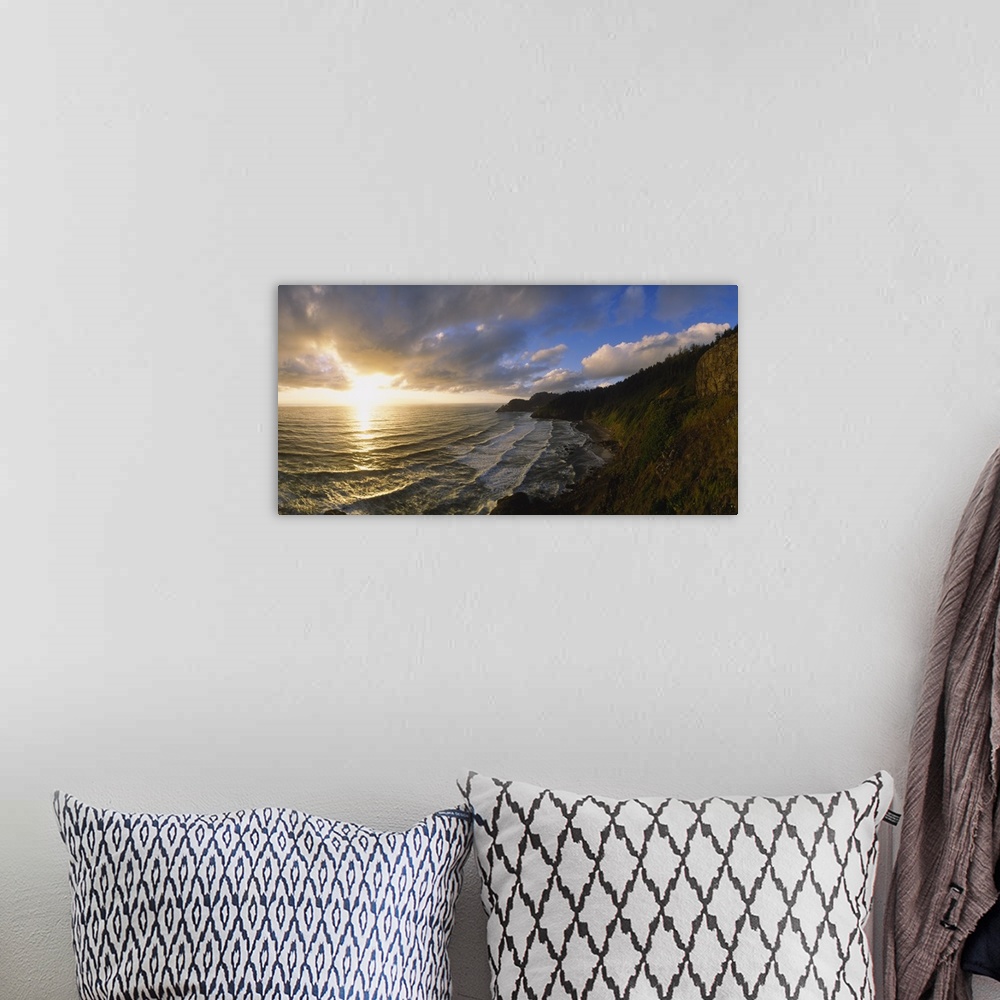 A bohemian room featuring Photograph of steep shoreline with waves rolling in under a bright cloudy sky at sunrise.