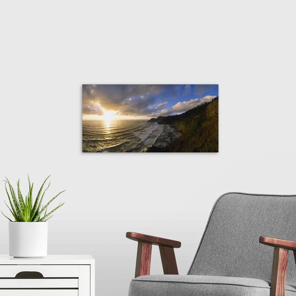 A modern room featuring Photograph of steep shoreline with waves rolling in under a bright cloudy sky at sunrise.