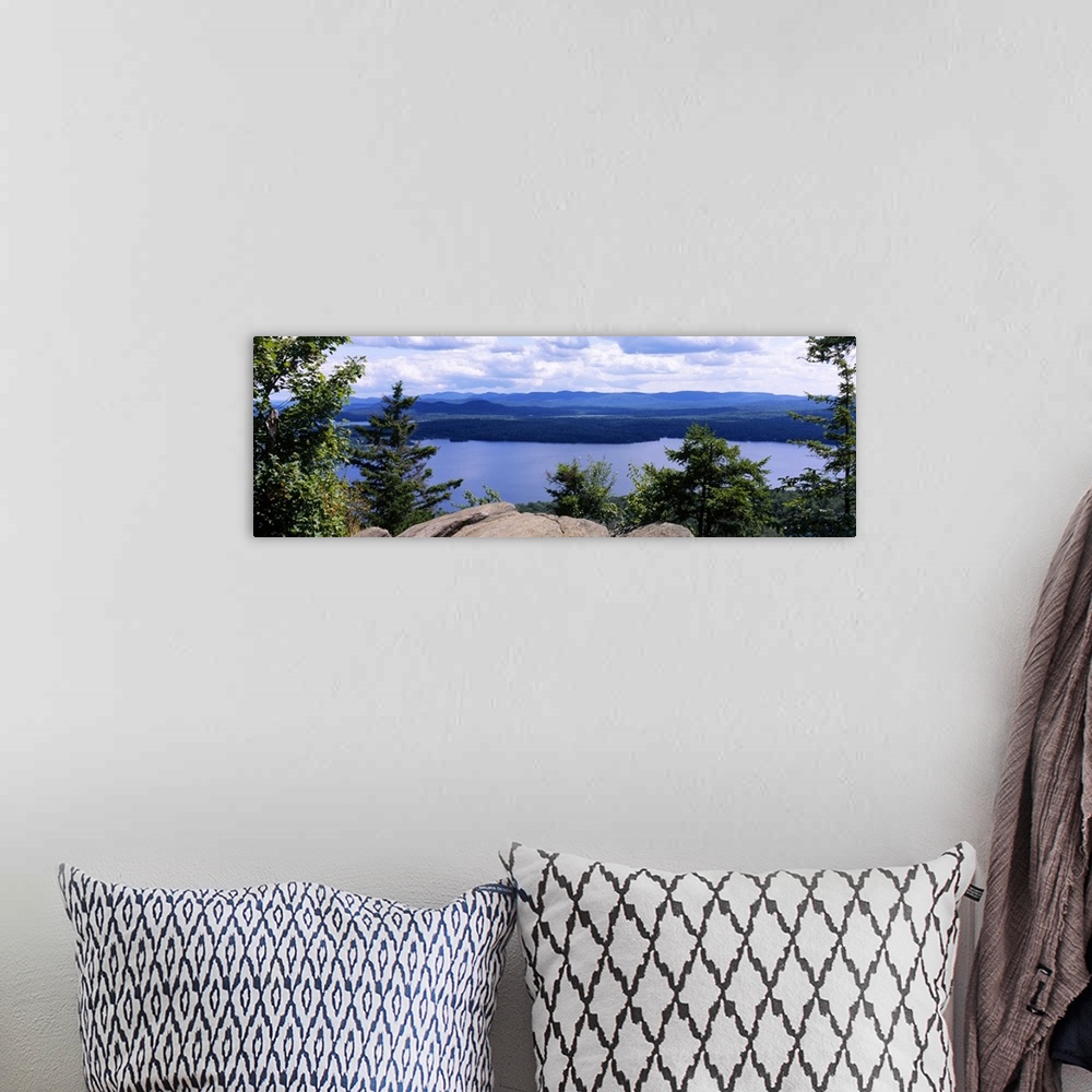 A bohemian room featuring Panoramic photograph of huge rock with surrounded by forest with river in the background and moun...