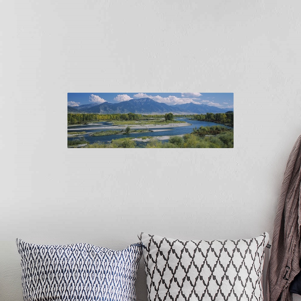 A bohemian room featuring Big wall panoramic wall docor of a river leading into a bigger body of water and mountains encase...