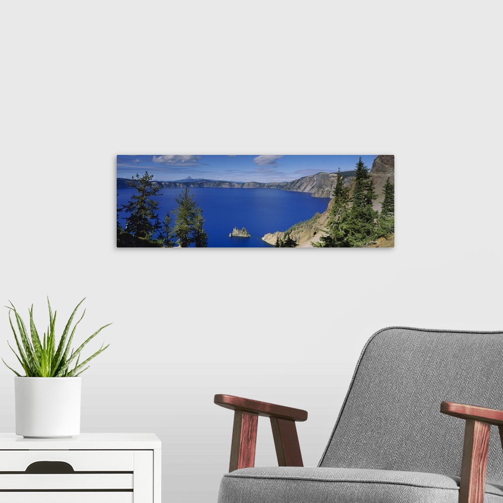 A modern room featuring Panoramic photograph taken from an aerial view overlooking a large body of water surrounded by mo...