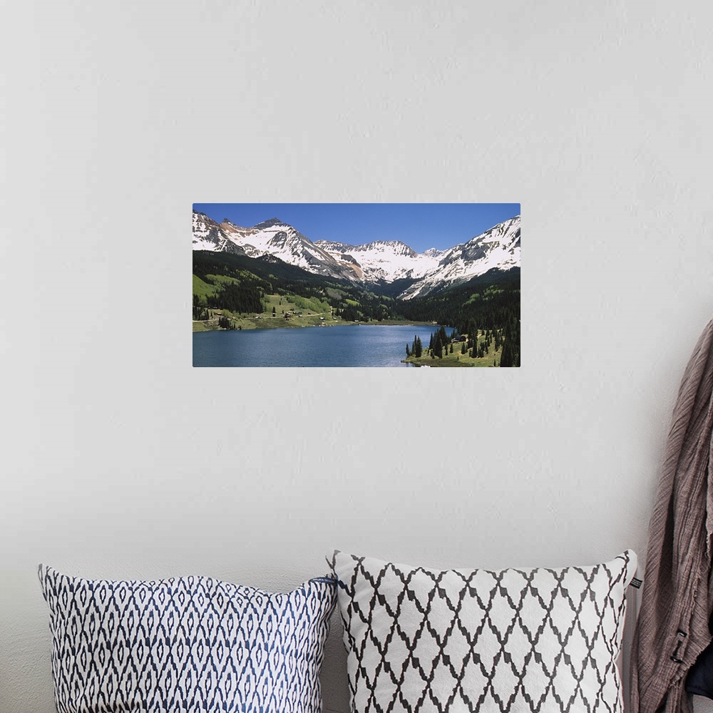 A bohemian room featuring Big photograph shows a range of snow-capped mountains surrounding a large body of water.  About h...