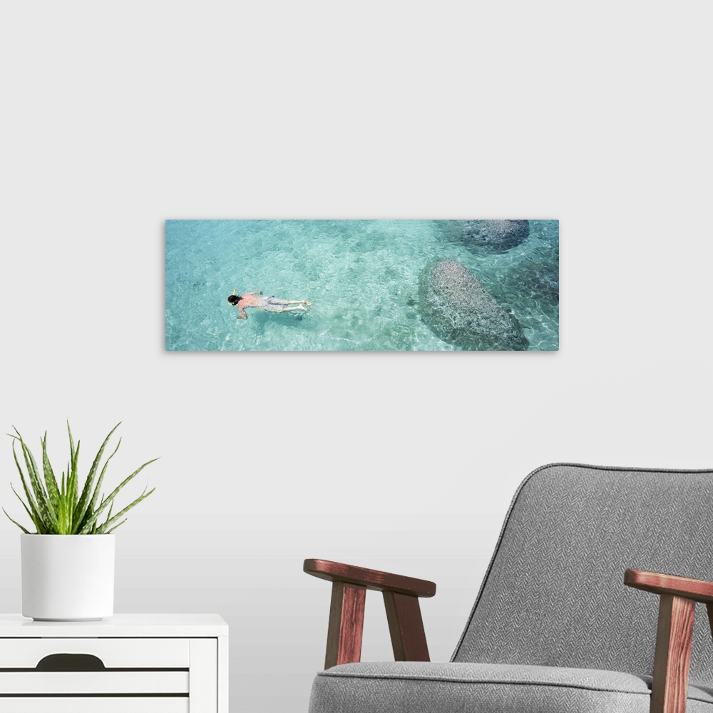 A modern room featuring High angle view of a man snorkeling