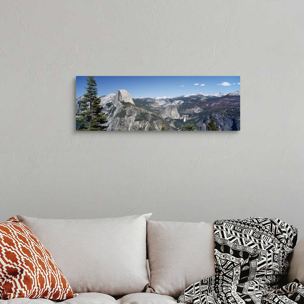 A bohemian room featuring Long and horizontal canvas photo of the Half Dome mountain in Yellowstone with mountains surround...