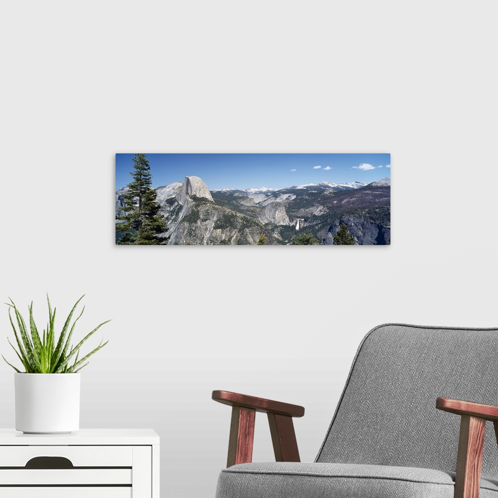 A modern room featuring Long and horizontal canvas photo of the Half Dome mountain in Yellowstone with mountains surround...