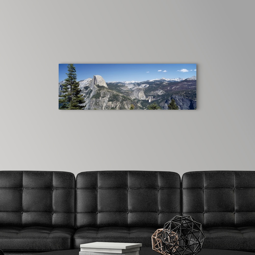 A modern room featuring Long and horizontal canvas photo of the Half Dome mountain in Yellowstone with mountains surround...