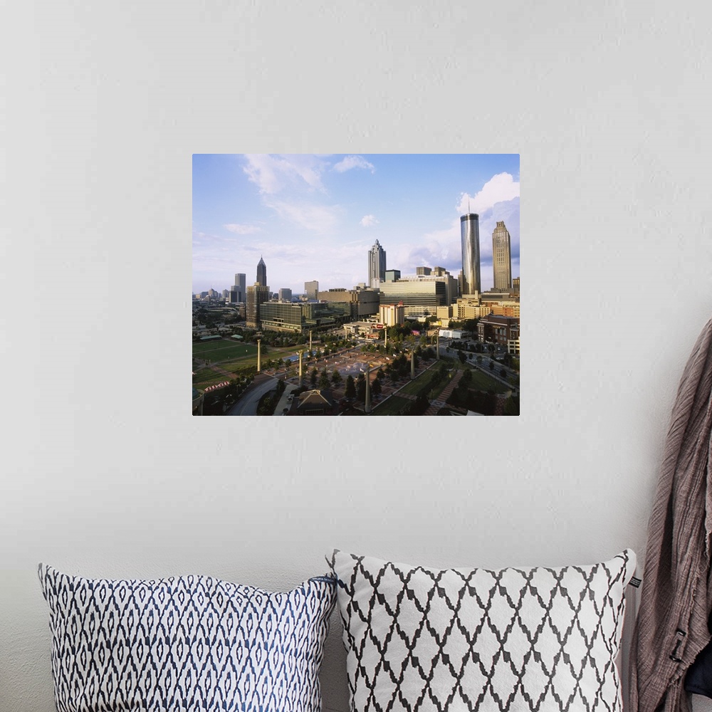 A bohemian room featuring Photo of Olympic Park with tall buildings in the background on canvas.