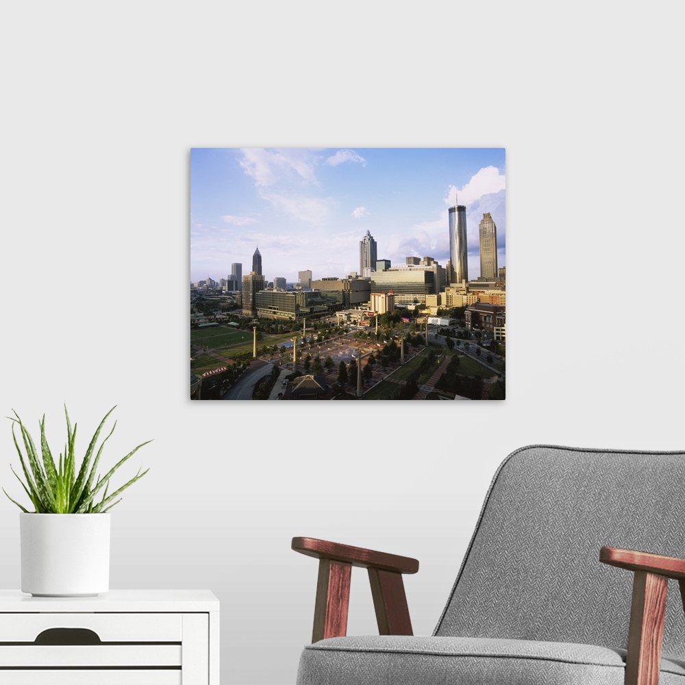 A modern room featuring Photo of Olympic Park with tall buildings in the background on canvas.