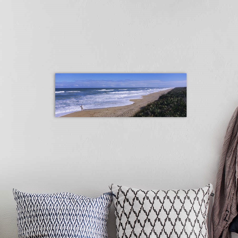 A bohemian room featuring High angle view of a person fishing on the beach, Playalinda Beach, Canaveral National Seashore, ...