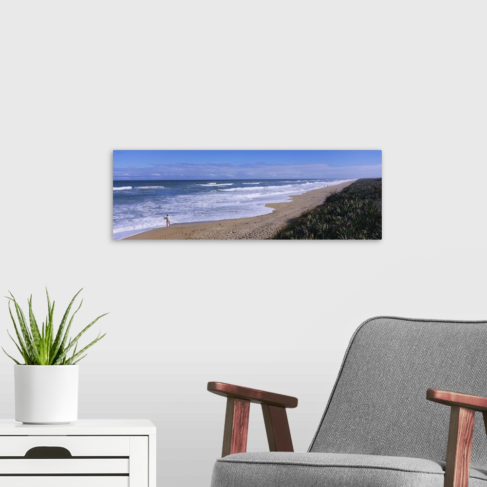 A modern room featuring High angle view of a person fishing on the beach, Playalinda Beach, Canaveral National Seashore, ...