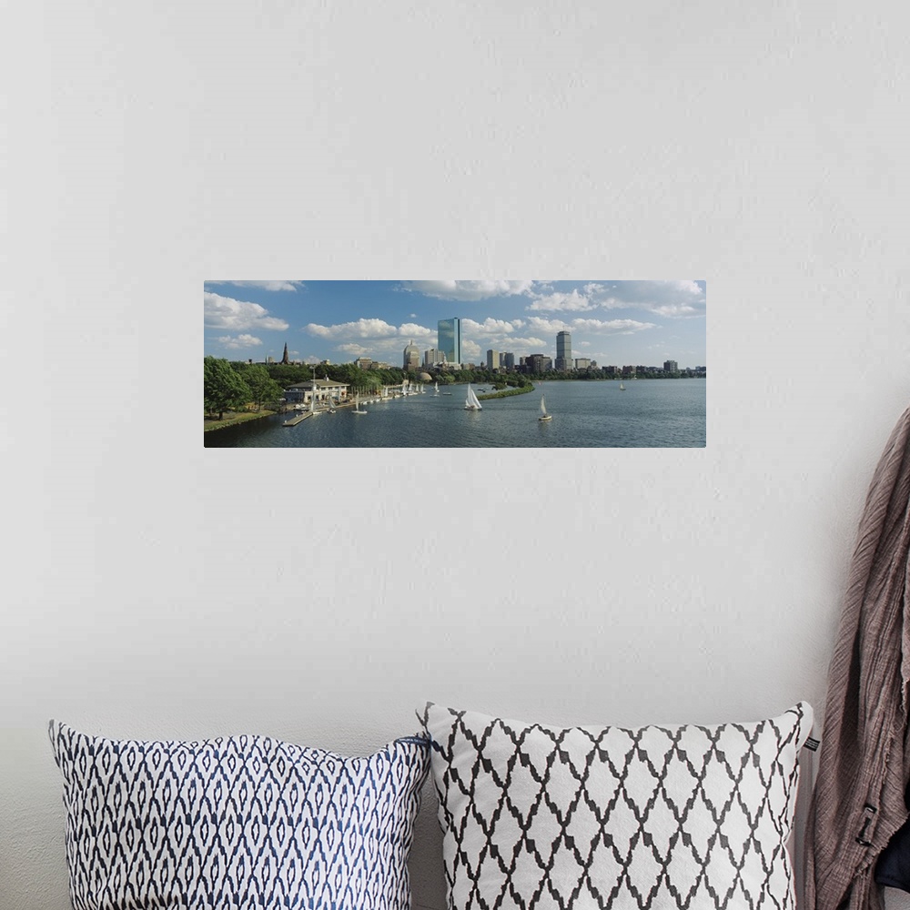 A bohemian room featuring A panoramic photograph of Charles river with sail boats and the Boston skyline in the background....