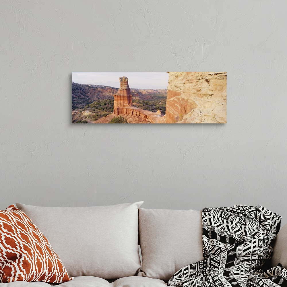 A bohemian room featuring Long photo print of rock formations in the desert in Texas.