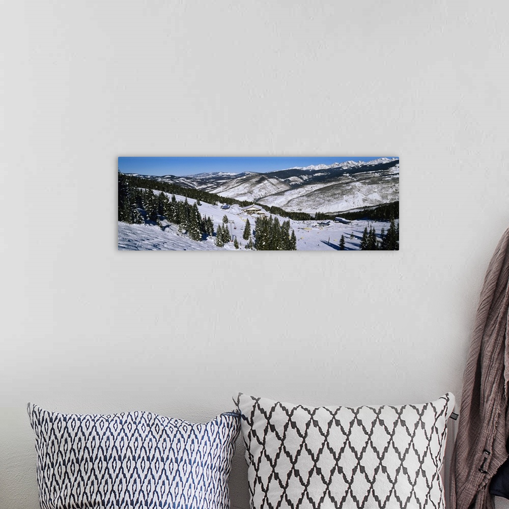 A bohemian room featuring Large landscape photograph of a snow covered hillside lined with trees, at a ski resort in Vail, ...