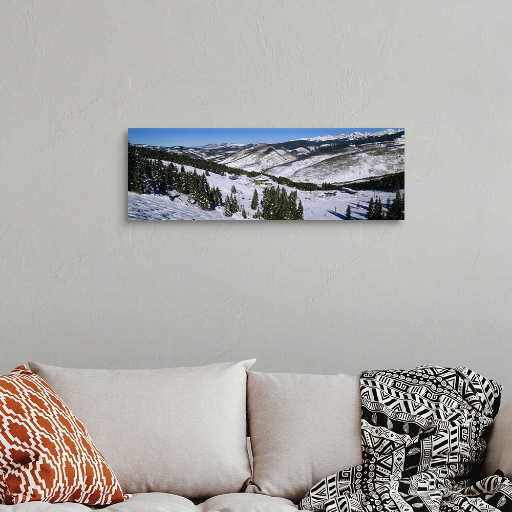 A bohemian room featuring Large landscape photograph of a snow covered hillside lined with trees, at a ski resort in Vail, ...